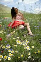 menina deitado baixa e relaxado dentro uma campo do flores foto