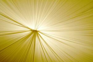 dourado luz raios em uma tecido fundo foto