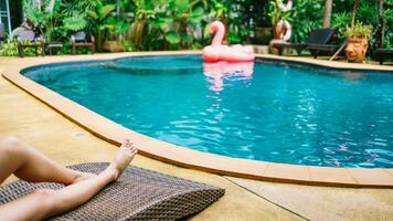 jovem ásia lindo mulher relaxante dentro natação piscina às spa recorrer. lindo tropical de praia frente hotel recorrer com natação piscina foto