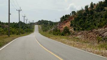 lindo aberto estrada ou país estrada dentro Indonésia com verde árvore em a esquerda e certo. calçada grandes estrada país lado. foto