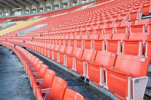 esvaziar laranja assentos às estádio, linhas do assento em uma futebol estádio foto