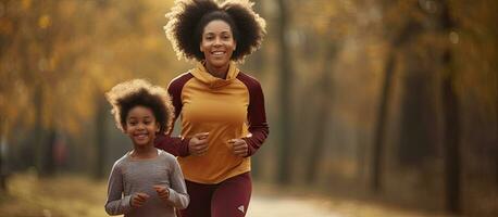 uma em forma africano americano mãe e dela filha exercício dentro uma parque vestindo Esportes vestuário promovendo uma saudável família conceito com acessível área para te foto