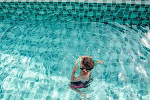 feriado, período de férias conceito, crianças natação dentro a piscina estão muito Diversão. foto