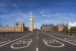 esvaziar estrada conduzindo para Westminster Palácio e grande ben com céu dentro fundo foto