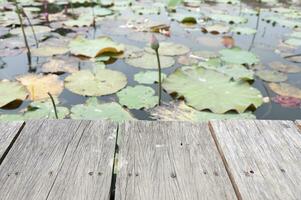 de madeira mesa atrás borrado lótus lagoa em natureza fundo foto