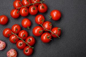 delicioso fresco cereja tomates em a galhos Como a ingrediente para cozinhando uma vegetariano prato foto