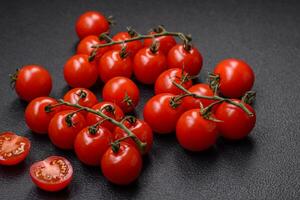 delicioso fresco cereja tomates em a galhos Como a ingrediente para cozinhando uma vegetariano prato foto