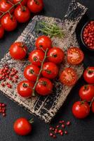 delicioso fresco cereja tomates em a galhos Como a ingrediente para cozinhando uma vegetariano prato foto
