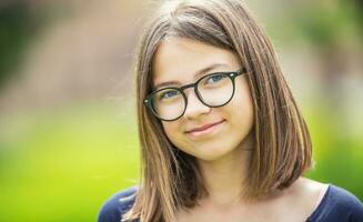 retrato do uma lindo sorrindo Adolescência menina com óculos foto