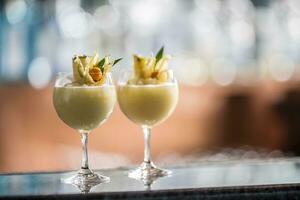 dois coquetéis pina colada às balcão de bar dentro noite clube ou restaurante foto