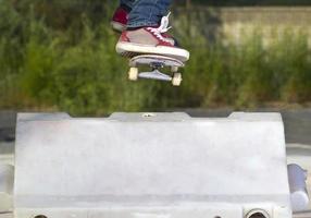 pulando um obstáculo com o skate foto