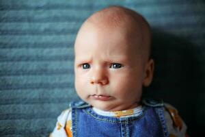 engraçado bebê 3 meses velho com uma sério face foto