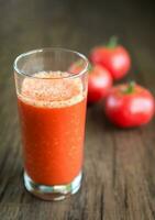 suco de tomate com tomates frescos foto