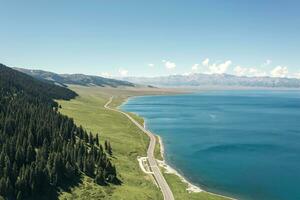 lago e pastagem com uma ensolarado dia. tiro dentro Sayram lago dentro xinjiang, China. foto