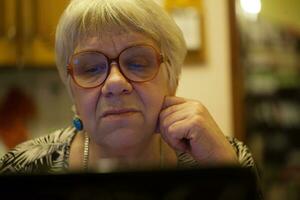moderno idosos mulher usando skype foto