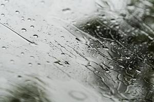 fundo de chuva forte, gotas de chuva no vidro da janela ao ar livre foto