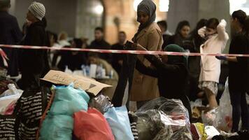 sírio refugiados ouvindo para anúncio às caridade colecionar ponto dentro copenhaga Ferrovia estação foto