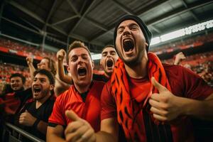 uma grupo do apaixonado fãs rugido dentro excitação Como a futebol estação chutes fora com uma emocionante jogos foto