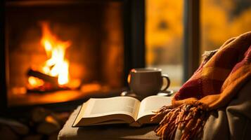 uma pessoa sentado de a lareira embrulhado dentro uma suave cobertor lendo uma livro cercado de colorida outono folhas foto