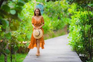 retrato bela jovem asiática caminhar no caminho caminhada no jardim foto