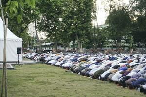 uma foto do muçulmano congregação Rezar eid al-adha dentro a campo
