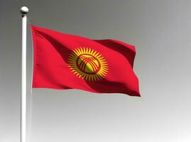 Quirguistão nacional bandeira acenando em cinzento fundo foto