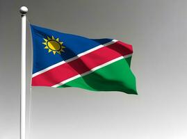 Namíbia nacional bandeira acenando em cinzento fundo foto