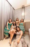 uma grupo do ásia mulheres dentro luxuoso vestidos estão esperando para jantar dentro uma hotel salão de baile foto