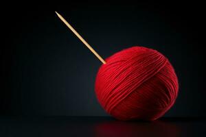 uma bola do vermelho fio com uma de madeira tricô agulha degola Fora do isto contra Sombrio fundo. ai gerado. foto