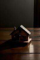 uma pequeno casa sentado em topo do uma de madeira mesa. ai gerado foto