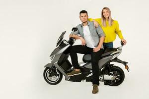 jovem atraente casal equitação a elétrico moto lambreta feliz tendo Diversão juntos foto