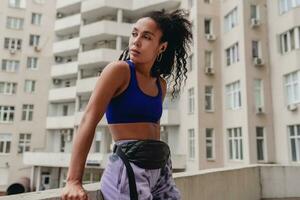 atraente Preto africano americano mulher dentro esporte ginástica equipamento em telhado fazer trabalhos Fora foto