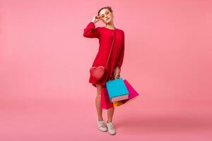 atraente feliz sorridente à moda mulher segurando compras bolsas foto