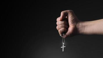 Imagens de close-up de crucifixo pendente e colar na mão foto