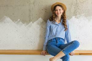 retrato do jovem bonita mulher com Palha chapéu jeans azul algodão camisa foto