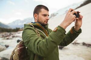 jovem hipster homem caminhada dentro montanhas, inverno período de férias foto