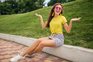 jovem à moda mulher tendo Diversão dentro cidade parque, verão estilo moda tendência foto