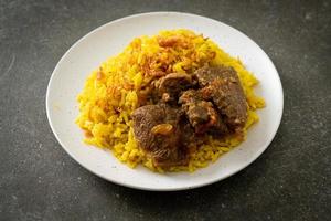 biryani de carne ou arroz com curry e carne - versão tailandês-muçulmana do biryani indiano, com arroz amarelo perfumado e carne bovina foto