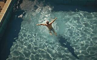 uma nadador realizando uma mergulho dentro uma natação piscina foto