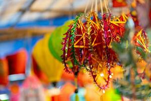 decorado colorida lanternas suspensão em uma ficar de pé dentro a ruas dentro ho chi minh cidade, Vietnã durante meio outono festival. chinês língua dentro fotos significar dinheiro e felicidade