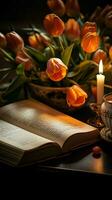 uma harmonioso plano deitar apresentando a aberto Bíblia, tulipas, suéter, chá, e velas vertical Móvel papel de parede ai gerado foto