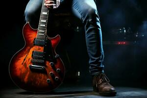 dentro a sombras, uma jovem homem vestindo azul jeans empunha a elétrico guitarra. ai gerado foto
