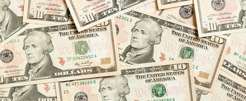 vista superior do fundo feito com notas de 10 dólares. dinheiro em usd. conceito de dinheiro americano foto