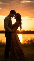 casal partilha uma beijo dentro frente do pôr do sol foto