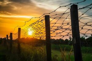 farpado fio cerca com crepúsculo céu para sentir silencioso e solitário e quer liberdade. neural rede ai gerado foto