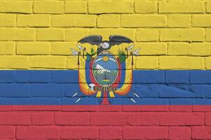 Equador bandeira retratado dentro pintura cores em velho tijolo muro. texturizado bandeira em grande tijolo parede alvenaria fundo foto