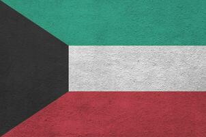 bandeira do kuwait retratada em cores de tinta brilhantes na parede de reboco em relevo antigo. banner texturizado em fundo áspero foto