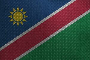 Namíbia bandeira retratado dentro pintura cores em velho escovado metal prato ou parede fechar-se. texturizado bandeira em rude fundo foto