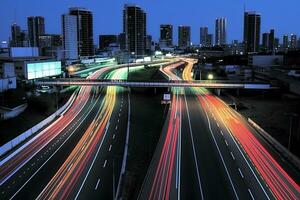 Tempo lapso fotografia do velozes comovente veículo luzes em a estradas do uma cidade. foto