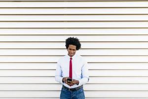 empresário negro usando um smartphone com fundo branco foto